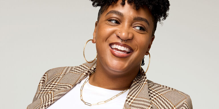 Woman with chin resting on hand wearing Timewise